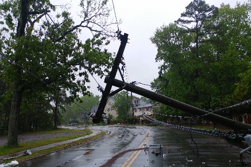 Storm damaged electricity pylon across a road.